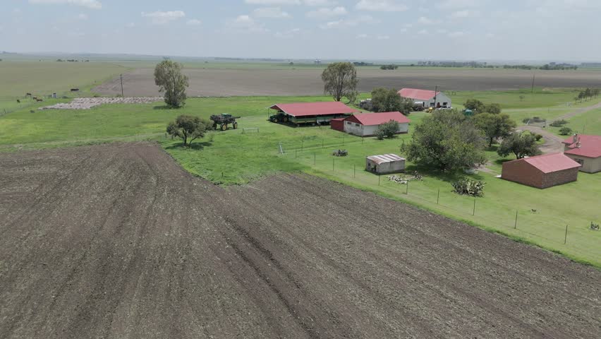 Aerial 4k footage of a farm house with farming equipment, a high speed sprayer for crops, driving around the farm. Royalty-Free Stock Footage #3421532035