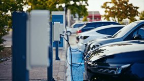 Electric cars recharging at the charging station. ev charging station. 4k - Powered by Shutterstock - Get 15% off with code: PIKWIZARD15