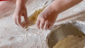 Home Khachapuri - popular Georgian Caucasian cousine baked meal dough prepraration moment. Womans hands making a khachapuri base forwith cheese filling on the flour covered home table. 4K footage.