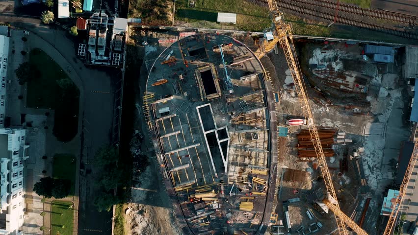 Aerial view of construction site with tower cranes working and building new skyscraper apartment house. Constuction industry