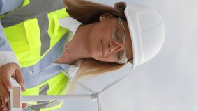Vertical video. Women's adherence to green values: an engineer explores the possibilities of wind energy to ensure environmental sustainability. Engineering innovation in wind energy: a woman develops