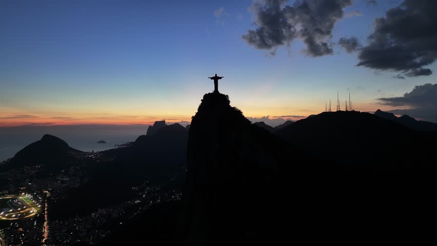 Sunset Christ The Redeemer At Rio De Janeiro In Rio De Janeiro Brazil. Corcovado Mountain. Illuminated City. Rio De Janeiro Brazil. Sunset Scenery. Christ The Redeemer In Rio De Janeiro Brazil.