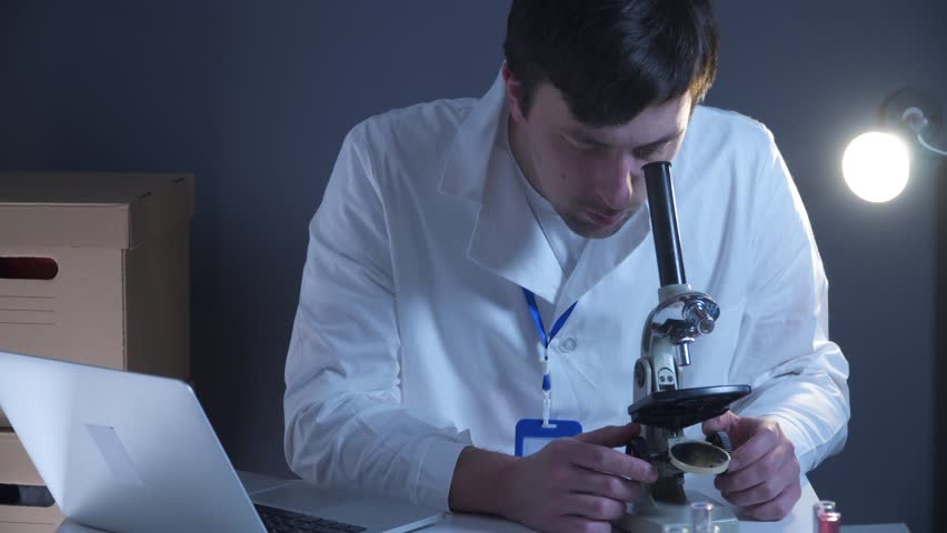 Scientist at workspace in laboratory with microscope, computer, and laboratory tools. Bio technology. Med students stuff. Medical assistant. Scientific research. Checking results on laptop in lab. Royalty-Free Stock Footage #3421810869
