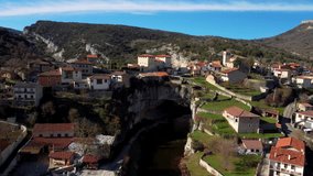 Aerial view of Puentedey, a picturesque village with a natural bridge over the river. Burgos, Spain. High quality 4k footage