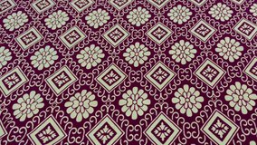 Video of floral fabric pattern, brown, ancient pattern, flowers in full bloom.
