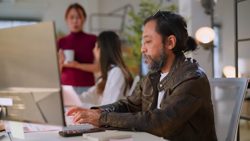 focused and dedicated work with asian male man concentrating on his tasks in the office professionalism concentration and a productive work environment making it an idea success work smartphone Royalty-Free Stock Footage #3422032855