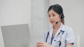 Asian woman doctor or physiotherapist video call to distant patient via computer online to teach and advice stretch muscles reduce symptoms of office syndrome at hospital. Technology healthcare online