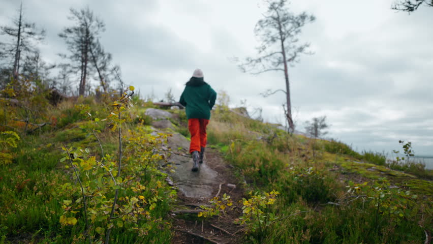 Young Woman Hiking And Climbing At Mountain Top, Following Shot, Traveling In Autumn Weekend