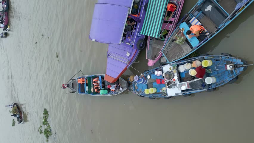 Vertical video. Cai Rang Floating Market in the Mekong Delta in Vietnam.