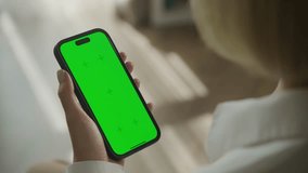 Person Holding Smartphone with Green Screen - Powered by Shutterstock - Get 15% off with code: PIKWIZARD15