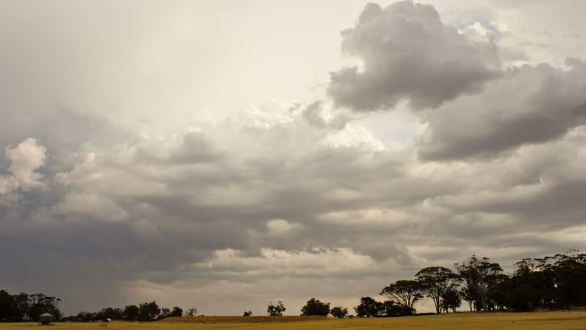 Time lapse of storm clouds brewing over an Australian summer landscape.