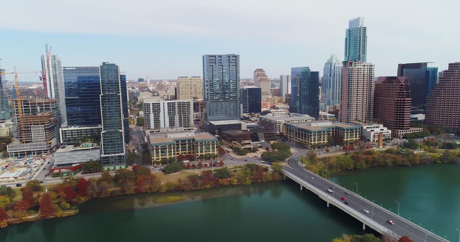 A slow forward high aerial establishing shot of the Austin, Texas skyline on a late Fall overcast day.  	