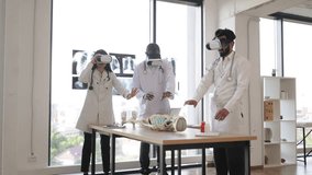 Education, science, vr, medical and health concept. Group of multiethnic doctors, biologists, archeologists, scientists wearing VR goggles study human skeleton in modern laboratory. - Powered by Shutterstock - Get 15% off with code: PIKWIZARD15