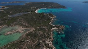 aerial drone approaching video of panoramic landscape in sardinia, italy with particular rocky geography of volcanic origin and turquoise and emerald Mediterranean sea