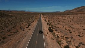 Modern car driving on desert highway in Nevada. Empty street to nowhere. Road from above in the dry hot Wild West America landscape. Aerial drone - Powered by Shutterstock - Get 15% off with code: PIKWIZARD15