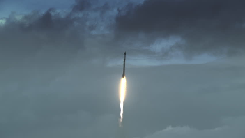 Commercial Space Rocket as lifts off through clouds and dramatic sky from Florida Space Center carrying four astronauts to the International Space Station. 4K slow-motion with audio.  Royalty-Free Stock Footage #3422548075