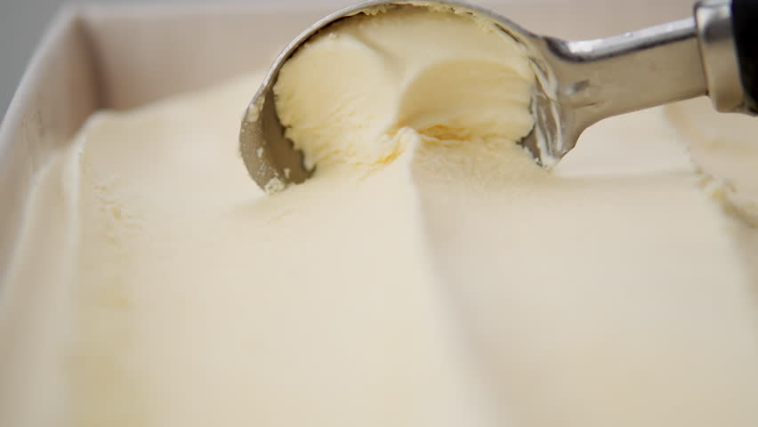 Close-up Vanilla ice cream scooped out of container, Front view Food concept.