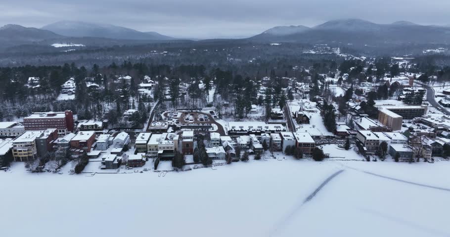 Afternoon winter aerial video of Mirror Lake in the Village of Lake Placid, New York. (01-05-2024)