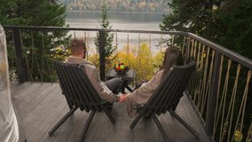 Man with woman intertwines hands on terrace at twilight. Setting provides idyllic backdrop for romantic retreat for couple among lavish and eco-friendly resort - Powered by Shutterstock - Get 15% off with code: PIKWIZARD15