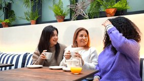 Three adult caucasian women talking happily in a colorful cafeteria - Powered by Shutterstock - Get 15% off with code: PIKWIZARD15