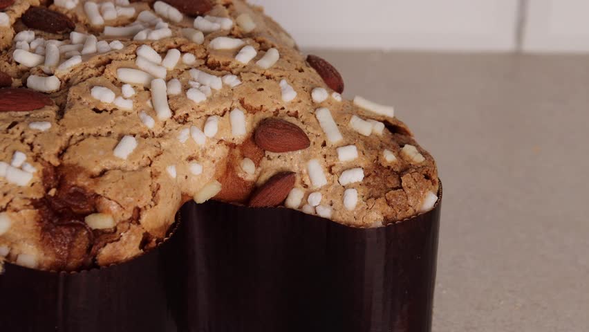 show the pulp of the Colomba Pasquale, a traditional Italian Easter cake shaped like a pigeon. This Easter bread, known as Colomba, is studded with nuts.