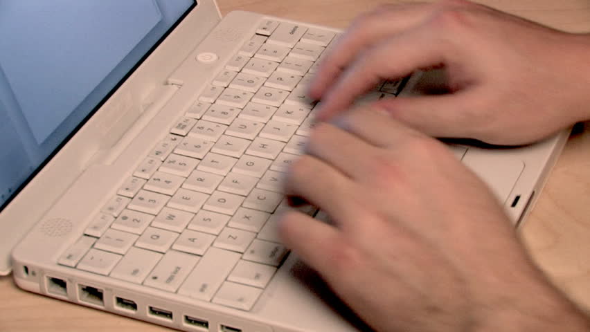 Typing on a laptop.
