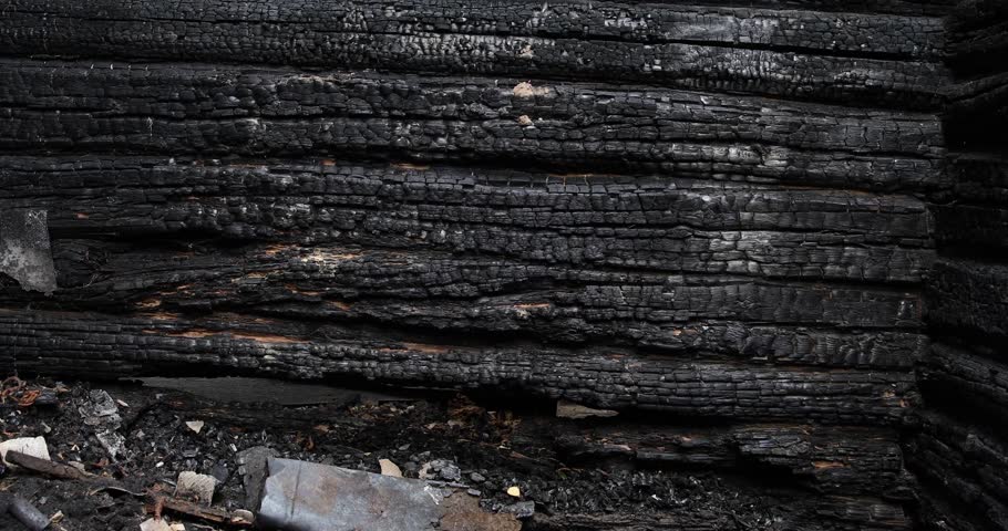 A burnt-out wooden house, a sauna or a barn. Burnt logs after the fire. Royalty-Free Stock Footage #3422903667