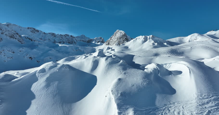 Winter drone shot of ski pistes and slopes covered with fresh powder snow in Tignes in Valdisere France