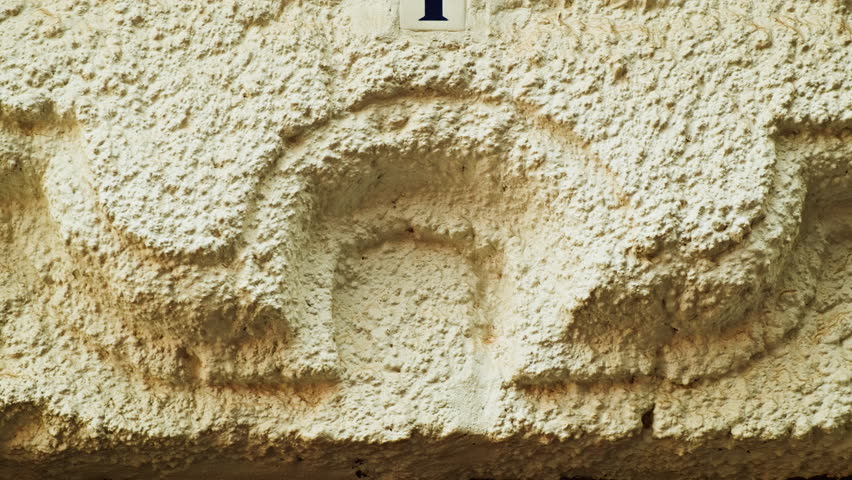 Number 1 (one) affixed to the exterior of a building, with an elegant, vintage and traditional appearance
