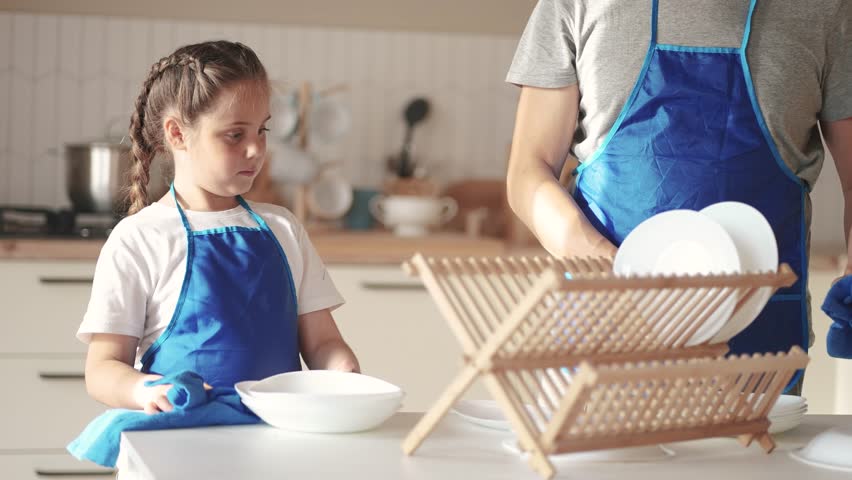 daughter and father washing dishes. happy family kid dream concept. child daughter in an apron together with dad in the kitchen wash dishes help parents. baby baby washing lifestyle dishes Royalty-Free Stock Footage #3422960609