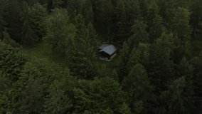 An aerial shot of the house in the woods on a cloudy day - Powered by Shutterstock - Get 15% off with code: PIKWIZARD15