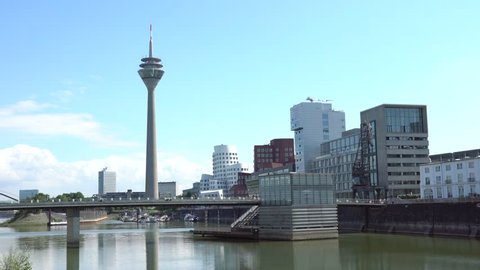 DUSSELDORF, GERMANY - AUGUST 14, 2017: The skyline of the Medienhafen harbour area. The shot includes the famous tilted towers designed by architect Frank Gehry on Rheinturm background.
