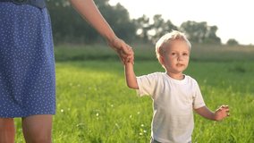 mother and baby son walking in the park. happy family walking in the park in nature relaxing outdoors. happy family kid dream concept. mother and lifestyle child walking in the park - Powered by Shutterstock - Get 15% off with code: PIKWIZARD15