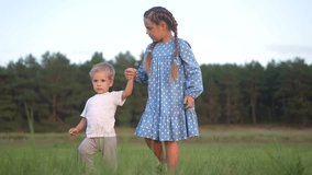 children brother sister in park. small children and baby walk in the park in nature holding hands. happy family kid dream concept. family small children walking on the grass in sun summer in park - Powered by Shutterstock - Get 15% off with code: PIKWIZARD15