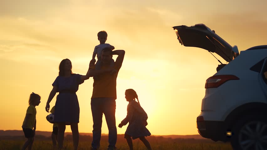 family by car resting in the park. family and children silhouette resting on the car playing ball at sunset in park on vacation. happy family kid dream sun concept. camping by car in the park Royalty-Free Stock Footage #3423017011