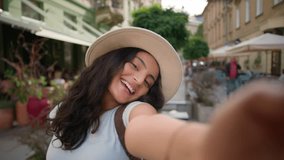 Happy positive smiling teen tourist traveler woman Indian Arabian ethnic female girl student taking selfie photo posing outside abroad city street cafe. Holidays memories vacations weekend relaxation - Powered by Shutterstock - Get 15% off with code: PIKWIZARD15