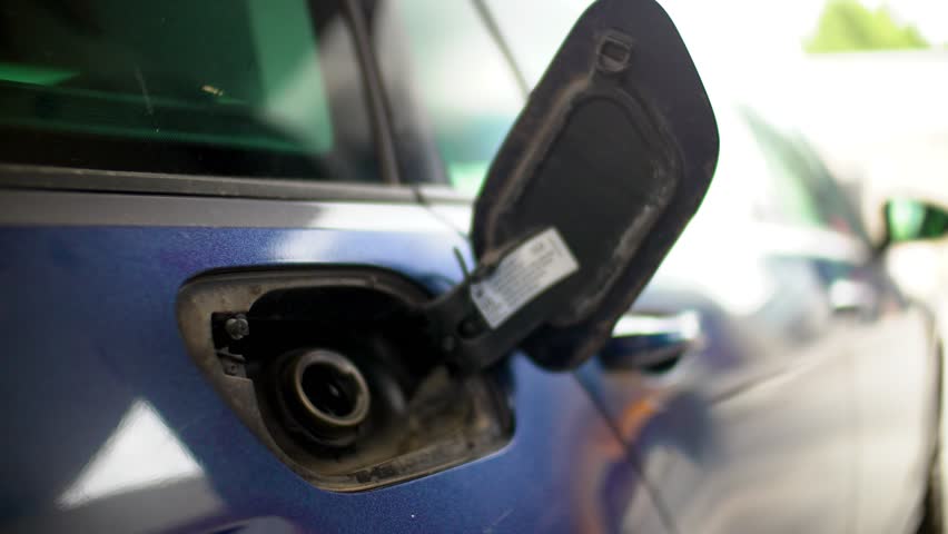 man filling benzine gasoline into car at gas station. Gasoline concept  price of fuel of a fill up (SP95 is type of gasoline not a logo or a brand, other footage like this has been already accepted) 