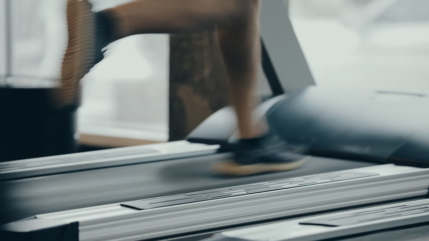 Male legs running on a treadmill in gym Royalty-Free Stock Footage #34231093