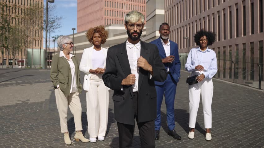 slow motion video of a group of multiethnic executives engage in lively business discussions while navigating through a city financial district.