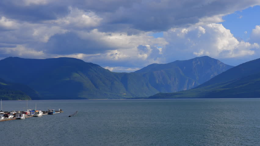 Establishing shot of lake with blue sky in Vancouver, Canada, North America. Day time on July 2023. Still camera view. ProRes 422 HQ.
