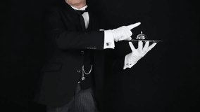 Butler or Waiter in Dark Formal Suit and White Gloves Ringing a Bell. Concept of Ring for Service. Professional Hospitality and Courtesy. - Powered by Shutterstock - Get 15% off with code: PIKWIZARD15