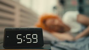 Young woman wakes up at six o'clock in the morning and turns the alarm clock off - Powered by Shutterstock - Get 15% off with code: PIKWIZARD15