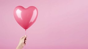 Happy Valentine's day motion text. Congratulations text appearing on a balloon in hand on pink backgropund. High quality 4k motion graphics - Powered by Shutterstock - Get 15% off with code: PIKWIZARD15