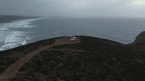 Aerial video of a vehicle on a cliff in Alentejo coast of Portugal in winter weather
