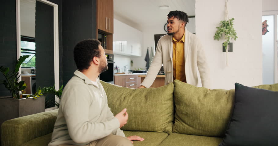 Gay, couple and conflict in home with fight, argument and stress on sofa for toxic relationship or fail. Lgbtq, people and angry on couch in living room with conversation, frustrated and pointing