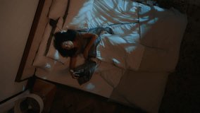 Sleepy young african american girl sleeping woman on bed in night home wake up early morning turn off alarm clock lack of sleep laziness waking irritated bad mood frustration insomnia disorder awake - Powered by Shutterstock - Get 15% off with code: PIKWIZARD15