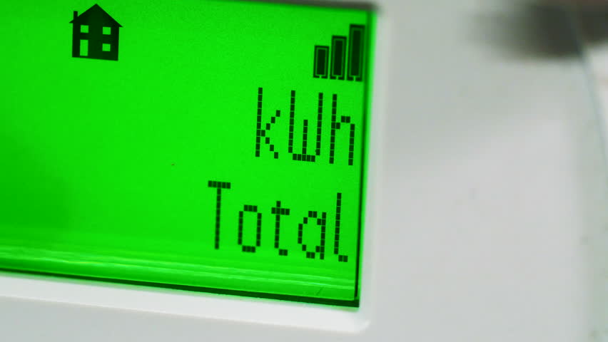 A close-up of an electricity smart meter. Green LCD panel displaying a flashing or beating heart symbol and kWh total sign. Concept for meter reading, energy, fuel bills, power and cost of living. Royalty-Free Stock Footage #3423227703