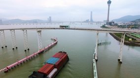 Macau aerial morning drone video city centre bridge ship water cargo