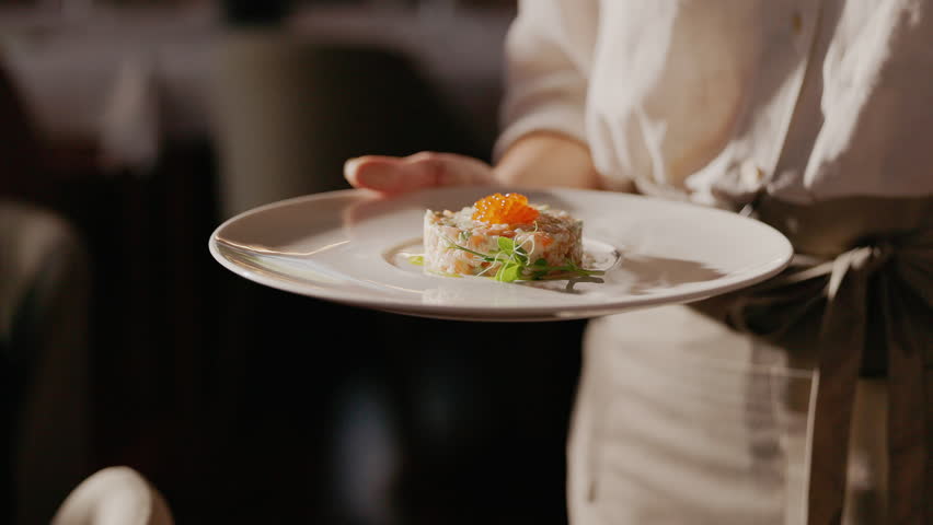 Waiter Carries Plate With Fish Roe Salad.