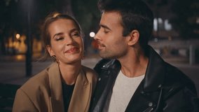 Gentle guy kissing girl cheek on date closeup. Smiling sweethearts in love resting urban park enjoy evening together. Relaxed stylish couple talk on street. Affectionate latino guy stroking girlfriend - Powered by Shutterstock - Get 15% off with code: PIKWIZARD15